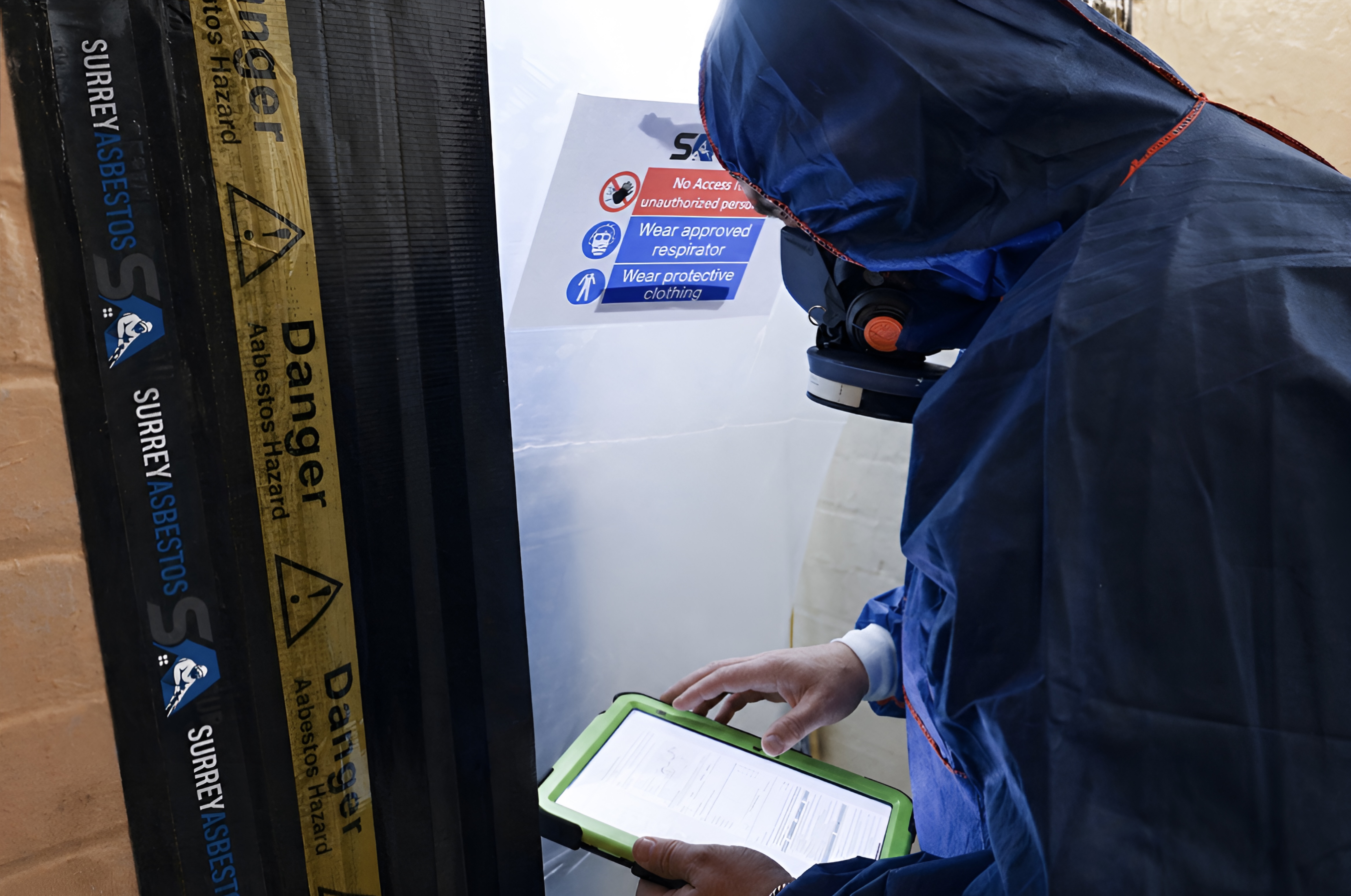 BOHS P402 qualified asbestos surveyor inspecting a property in Surrey
